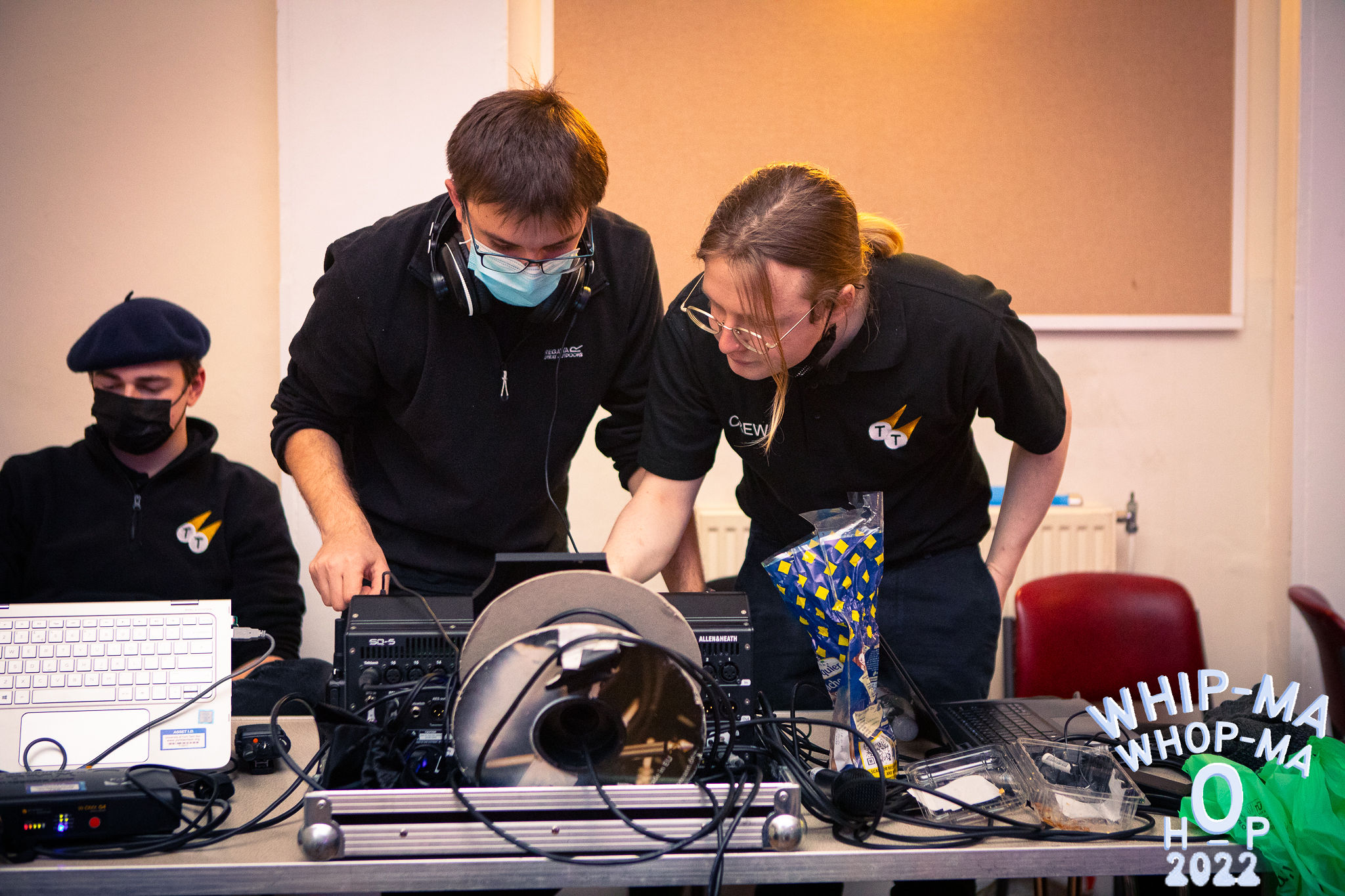 Three society members operating at an event